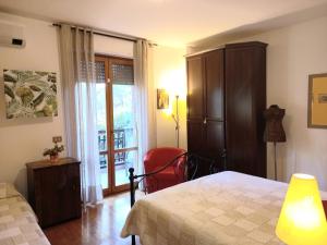a bedroom with a bed and a chair and a window at Freetime in Perugia