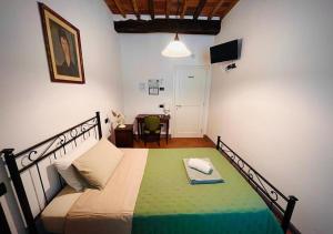 Postel nebo postele na pokoji v ubytování B&B Giardino delle Camelie