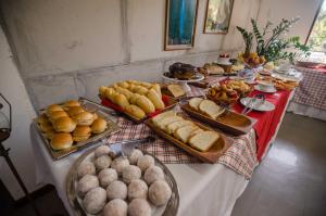 a table topped with lots of bread and other foods at Alpes Hotel in Venda Nova do Imigrante