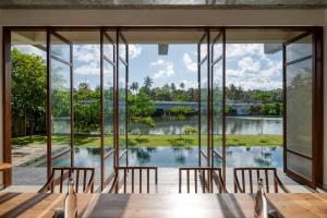 a dining room with a view of the water at Sitara Weligama in Weligama