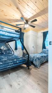 two bunk beds in a room with a ceiling fan at Wally's House in Hawley