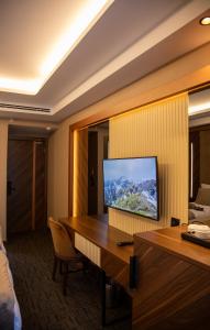 a hotel room with a desk with a flat screen tv at THE PARK HOTEL in Istanbul