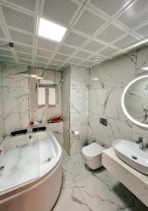 a bathroom with a tub and a toilet and a sink at THE PARK HOTEL in Istanbul