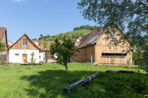 a barn with a tree in a field at Critz Cross in Criţ