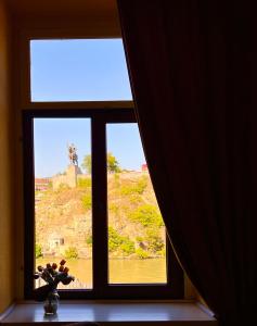 a window in a room with a view of a mountain at Old Ubani Apartment in Tbilisi City