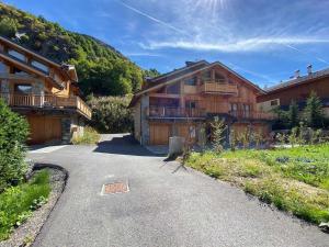 a house on a road next to a mountain at Appartement Saint-Martin-de-Belleville, 5 pièces, 8 personnes - FR-1-570-26 in Levassaix