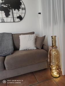 a living room with a couch and a vase on the floor at AtticoCinque in Bari