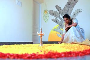 a young woman sitting in front of a birthday cake at Aryavilla Heritage in Varkala