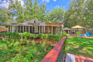 a home with a wooden bench in front of a yard at Creekside Cabins - The Getaway in Wimberley