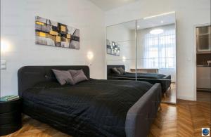 a bedroom with a large bed and a mirror at Downtown Dimond in Budapest