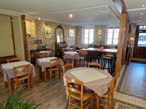 a restaurant with tables and chairs in a room at Hôtel De La Ferté in Chagny