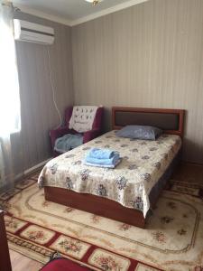 a bedroom with a bed with two towels on it at Petrovsk Hotel in Makhachkala