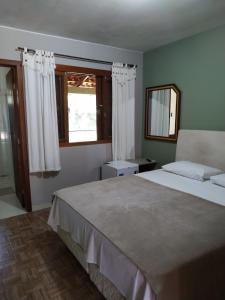 Cama ou camas em um quarto em Pousada Falls Park