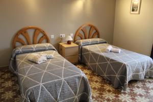 a bedroom with two beds with towels on them at Casa Rural LA COSTANILLA in Lituénigo