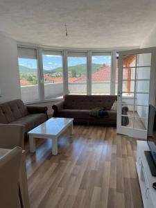 a living room with a couch and a table at Apartment in Mitrovicë, Kosovë in Mitrovicë