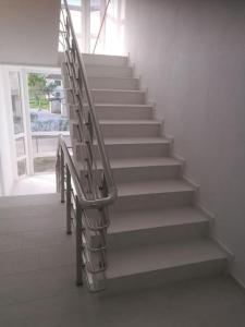 a set of stairs with a metal hand rail at Apartment in Mitrovicë, Kosovë in Mitrovicë