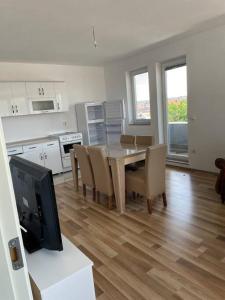 a kitchen and dining room with a table and chairs at Apartment in Mitrovicë, Kosovë in Mitrovicë