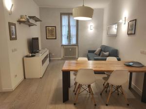 a living room with a table and chairs and a couch at Bergamo Alta Guest House in Bergamo