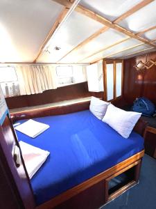 a large blue bed in the back of a boat at Beforelunch Cruise in Fethiye