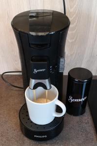 a coffee maker is making a cup of coffee at Waterfront Suite l Ballstad l Lofoten l Norway in Ballstad