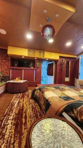 a bedroom with a large bed and a rug at Waterfall Hut - Live by a waterfall كوخ الشلال - عش وسط شلال in Amman