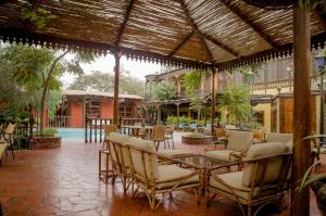 een patio met stoelen en een tafel bij Hotel & Hacienda El Carmelo in Ica