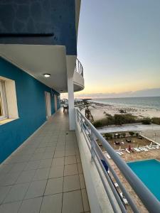 a balcony of a building with a view of the beach at Résidence Le Monaco Sousse in Sousse