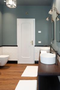 a bathroom with two sinks and a white door at Caffè delle Rose Les Chambres in Verbania