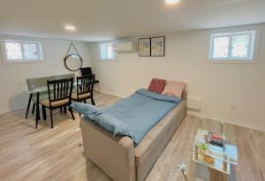 a living room with a couch and a table at Morden Unit with Free Parking, 10 km to downtown in Toronto