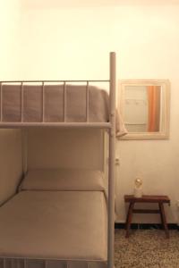 a bunk bed in a room with a table at Casa Marina in Colònia de Sant Jordi