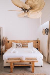 a bedroom with a large bed with a wooden headboard at Sol Ramon boutique hotel in Mitzpe Ramon