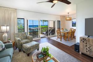 a living room with a couch and a table and chairs at Kaha Lani #222 in Lihue