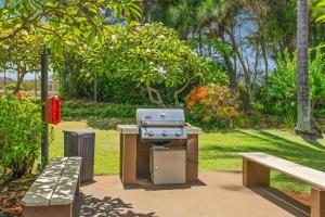 a grill in a park next to a bench at Kaha Lani #222 in Lihue
