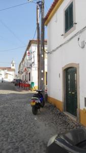 a scooter parked on a street next to a building at Casa de Alpalhão in Alpalhão