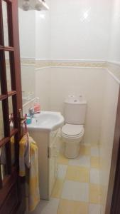 a bathroom with a white toilet and a sink at Casa de Alpalhão in Alpalhão +5 photos