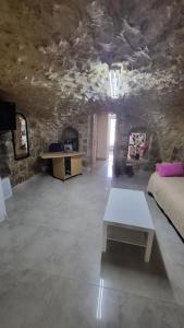 a living room with a couch and a table at historic luxury cave in Jerusalem