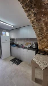 a kitchen with a white refrigerator and a counter top at historic luxury cave in Jerusalem