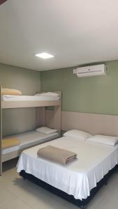 two beds in a room with two bunk beds at Pousada Falls Park in Foz do Iguaçu