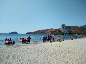 a group of people standing on a beach at Tucurinca in Santa Marta