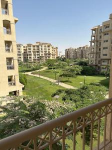 a view of a park in a city with buildings at شقة في مدينتي بي 2 جديدة in Madinaty