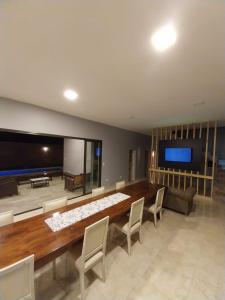a large living room with a large table and a flat screen tv at Casa del Sol in Salta