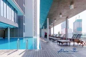 a building with a swimming pool and benches on a deck at Alviv 99 Suites I Family Suite I 4-7 pax I 5minsMelakaCruise I JonkerSt2 in Malacca