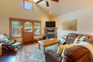 a living room with a couch and a fireplace at Running Bear in the Rockies #6145 in Estes Park