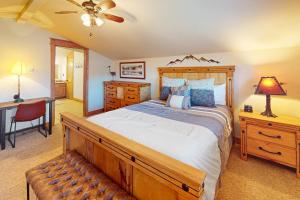 a bedroom with a large wooden bed and a desk at Running Bear in the Rockies #6145 in Estes Park