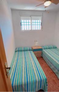 Postel nebo postele na pokoji v ubytování VARADERO OROPESA DEL MAR