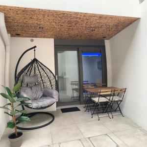 - une terrasse couverte avec une balançoire, une table et des chaises dans l'établissement Residentie Don, à Bruges