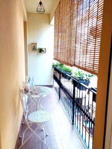 a balcony with a table and chairs and a window at Casa Ida in Pesaro