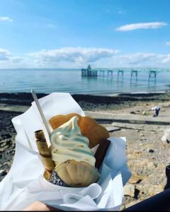 a plate of food with a pastry on the beach at Converted Barn at Stonehouse Farm 