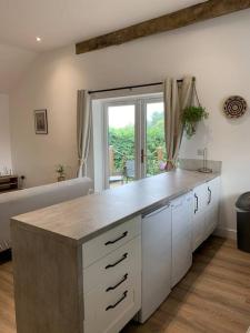 a kitchen with a counter top in a room at Converted Barn at Stonehouse Farm 