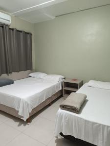 Cama ou camas em um quarto em Pousada Falls Park